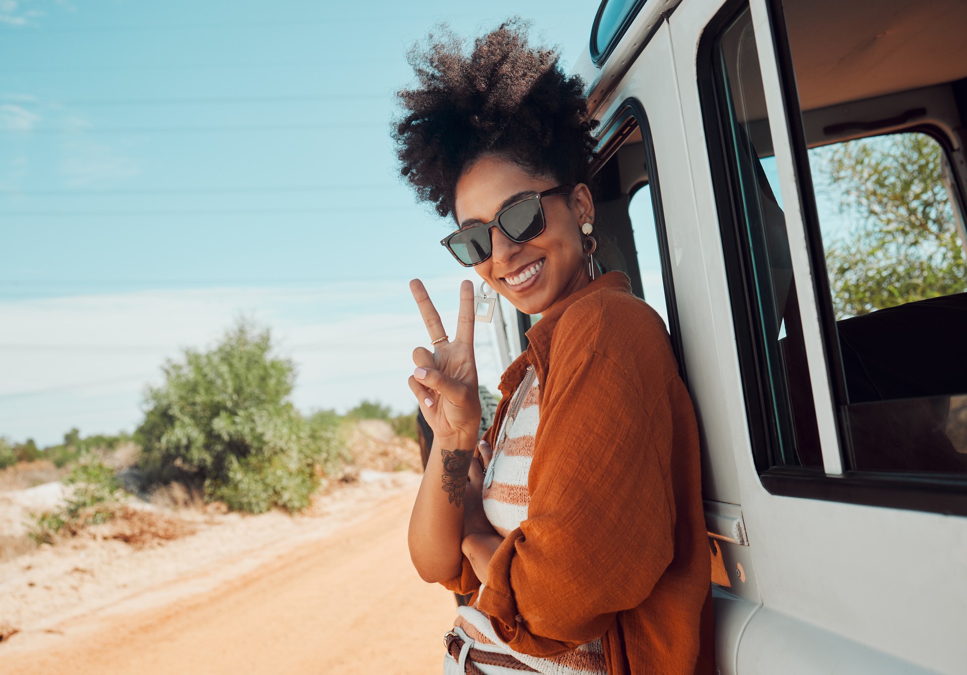 Travel, van and woman with peace hand sign on road trip in Mexico, happy, relax and smile. Summer, nature and journey in a countryside with a black woman excited about adventure and hipster lifestyle